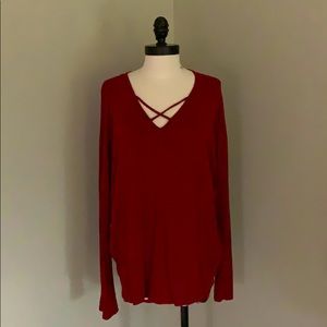 Red long sleeve top with cross cross design.